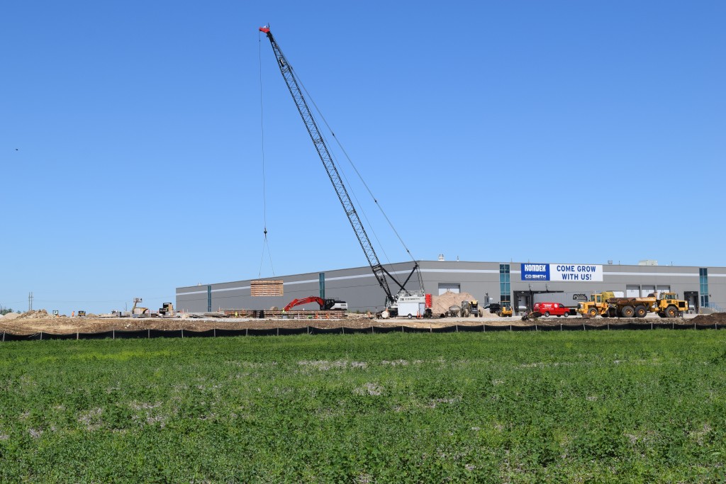 6-9-22: Crane lifting concrete forms 