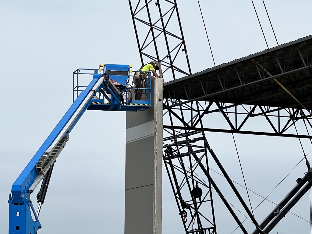 7-11-22: Securing a relocated precast panel to the new south exterior